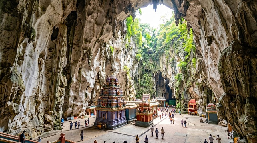 Огромный зал Temple Cave с просветом к небу, сине-фиолетовая башня святилища и маленькие храмы